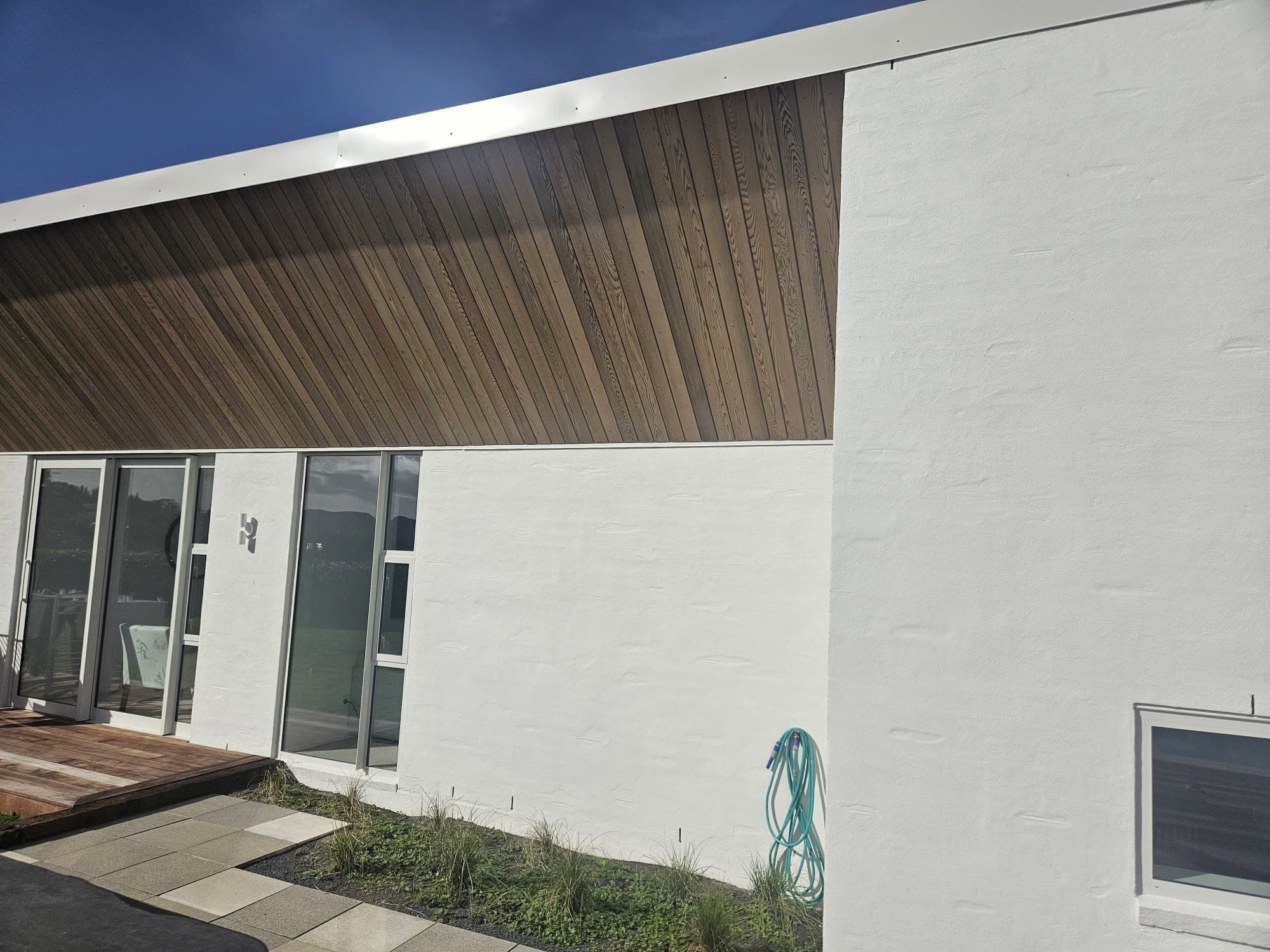 New build with plastered walls and timber cladding feature